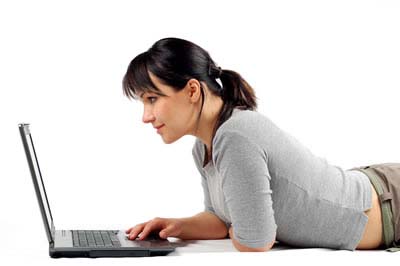 Young woman looking at her laptop